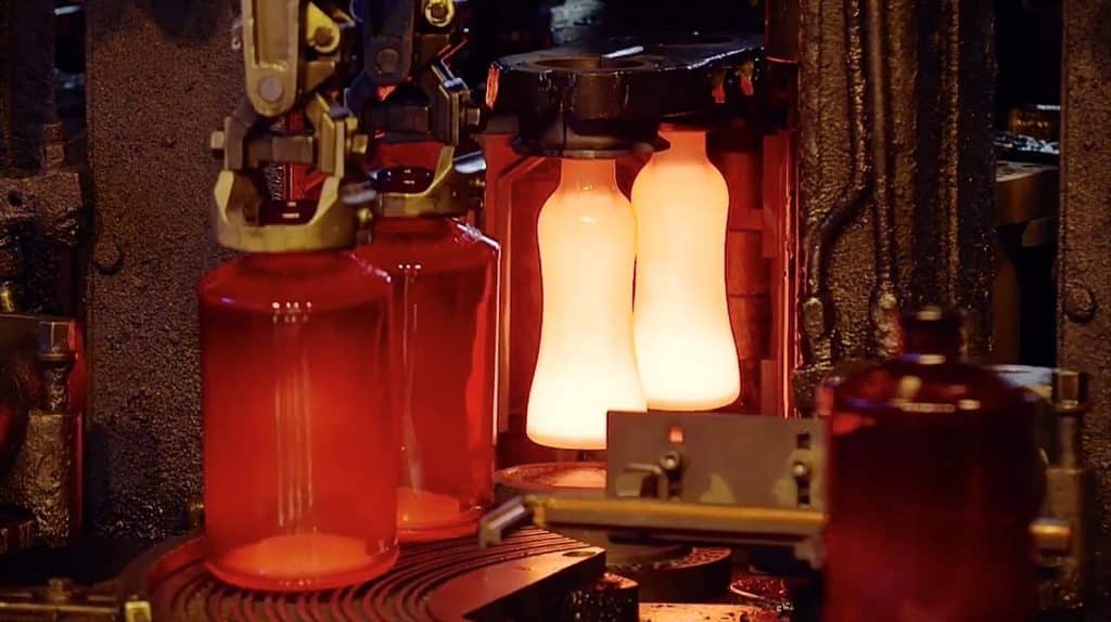 Red-hot glass gobs entering the blank moulds of an IS forming machine
