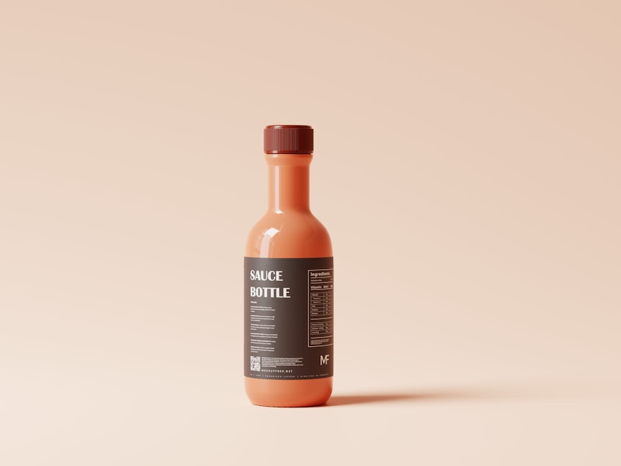 Woozy-style glass hot sauce bottle on a soft neutral backdrop