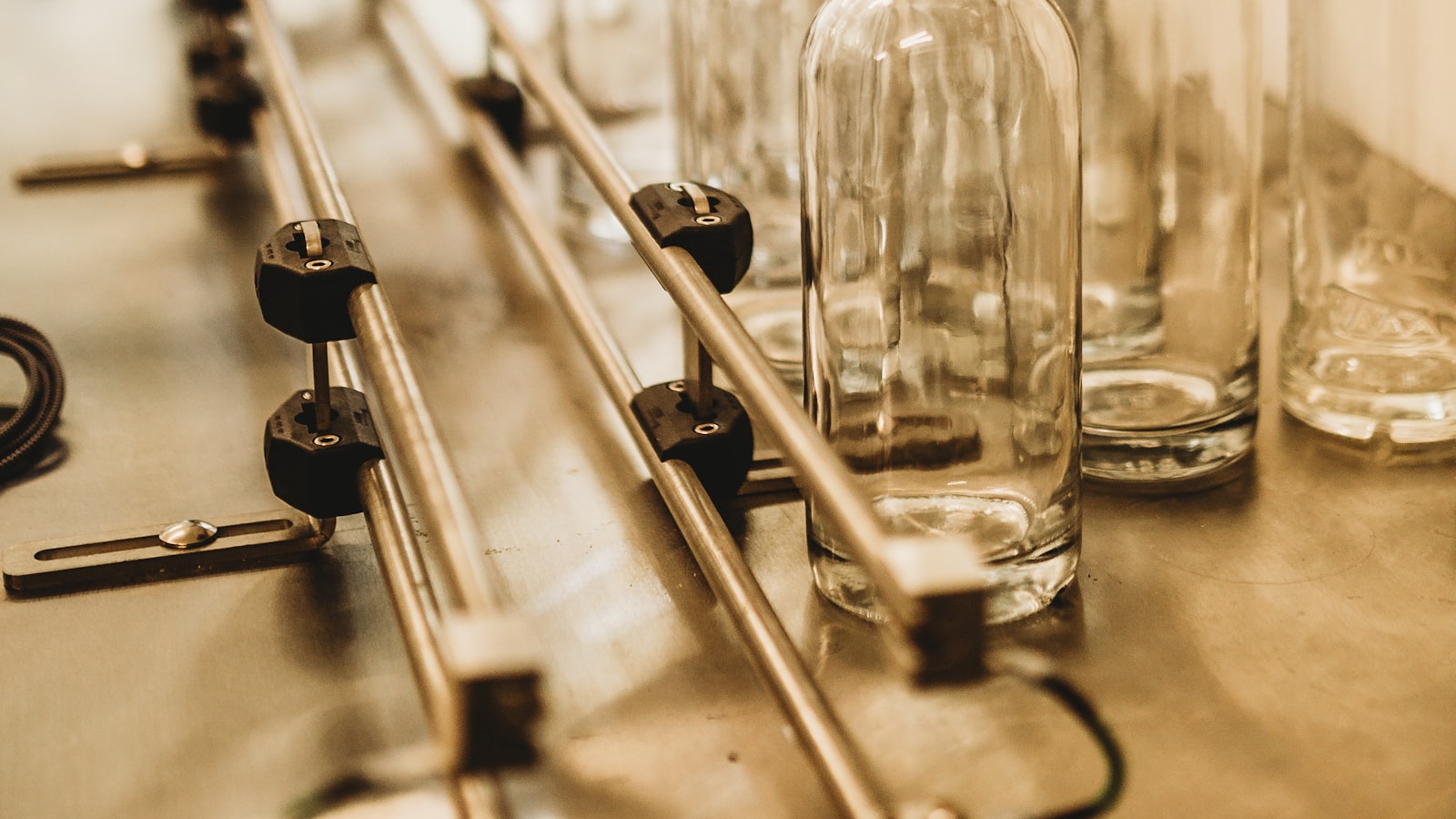 Empty glass bottles moving along a cold-end conveyor
