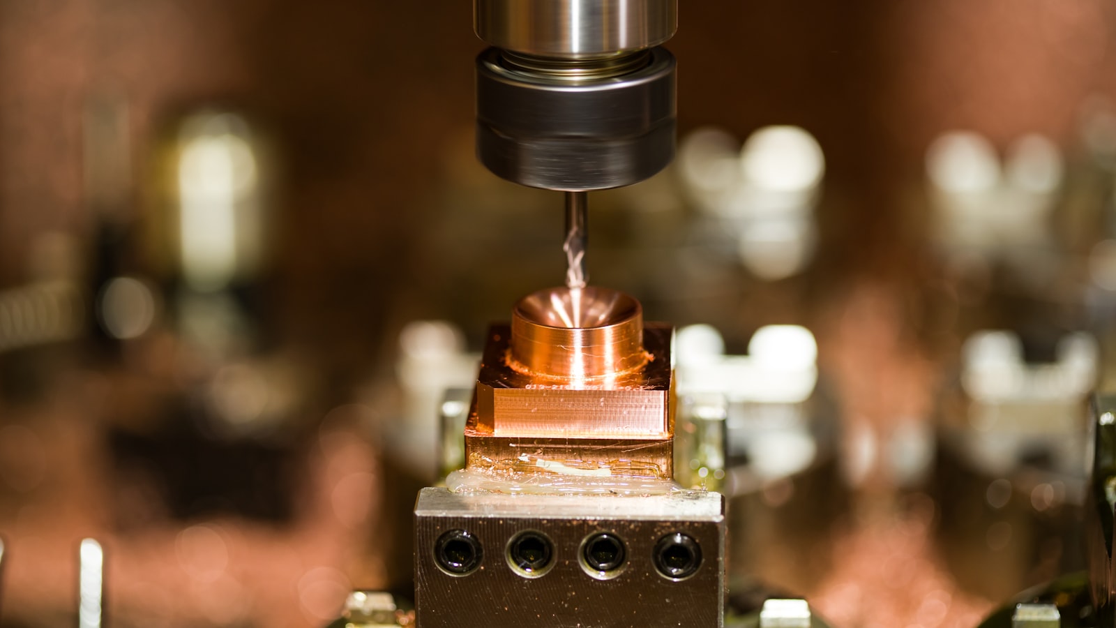 A CNC machine cutting a cavity into a steel bottle mould