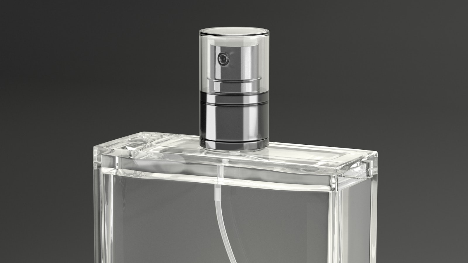 An empty rectangular glass perfume flacon on a grey background