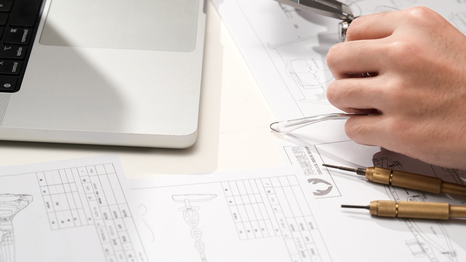 A technical drawing with dividers resting on the dimensions