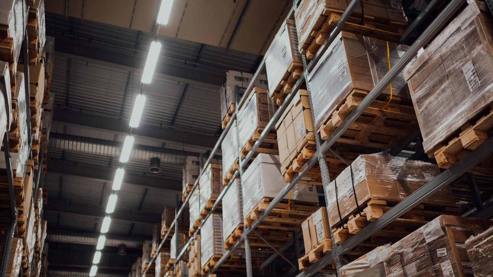 Pallets of goods stacked high in warehouse racking