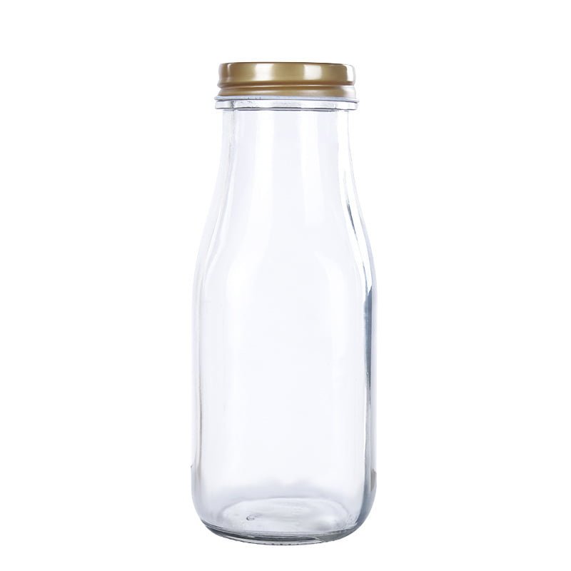 Botella para leche estilo cafetería de vidrio transparente, vacía y con tapa dorada a rosca