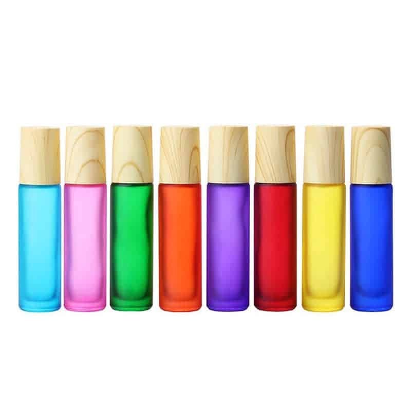 Eight coloured frosted roller bottles with bamboo caps in a row