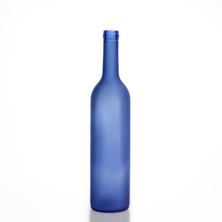 Blue Bordeaux wine bottle standing empty on a plain background