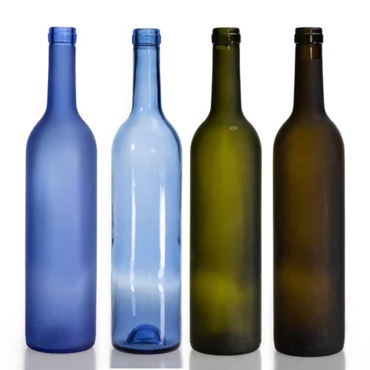 Bordeaux wine bottles in blue and antique green, empty, standing together