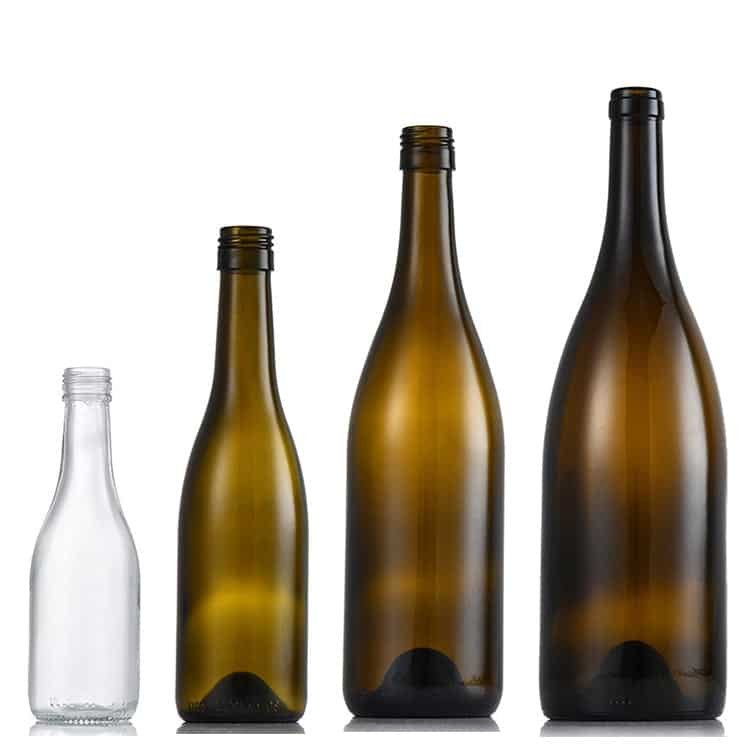 Four burgundy wine bottles in a size ladder from a quarter bottle to a magnum