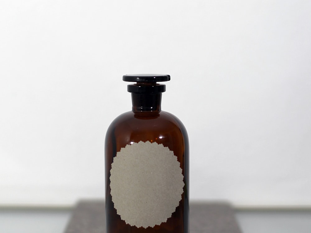 Amber glass bottle with a blank label ready for decoration